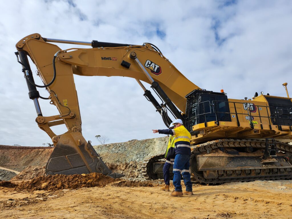 Mineral Mining Services heavy‑haul truck and excavator working on a mine site in Western Australia.