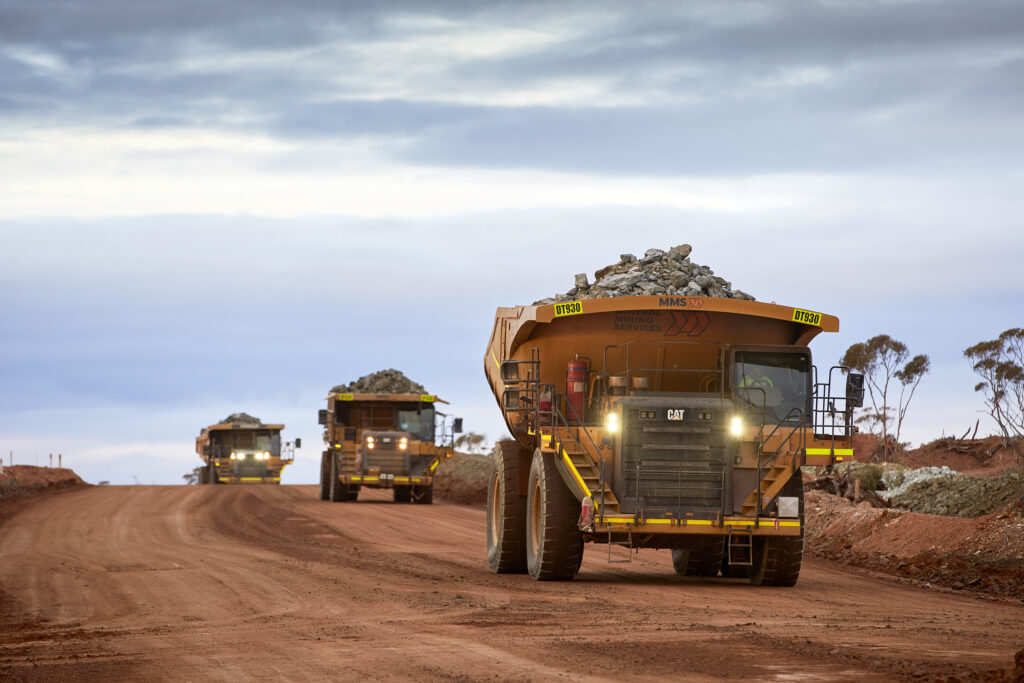 fleet-of-haul-trucks-driving-through-mine-site
