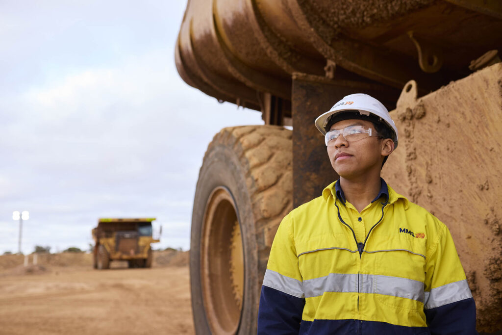 young-heavy-duty-mechanic-in-front-haul-truck