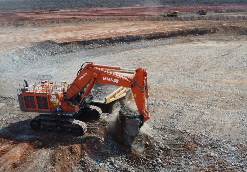 birds-eye-veiw-of-orange-excavator-digging-up-dirt