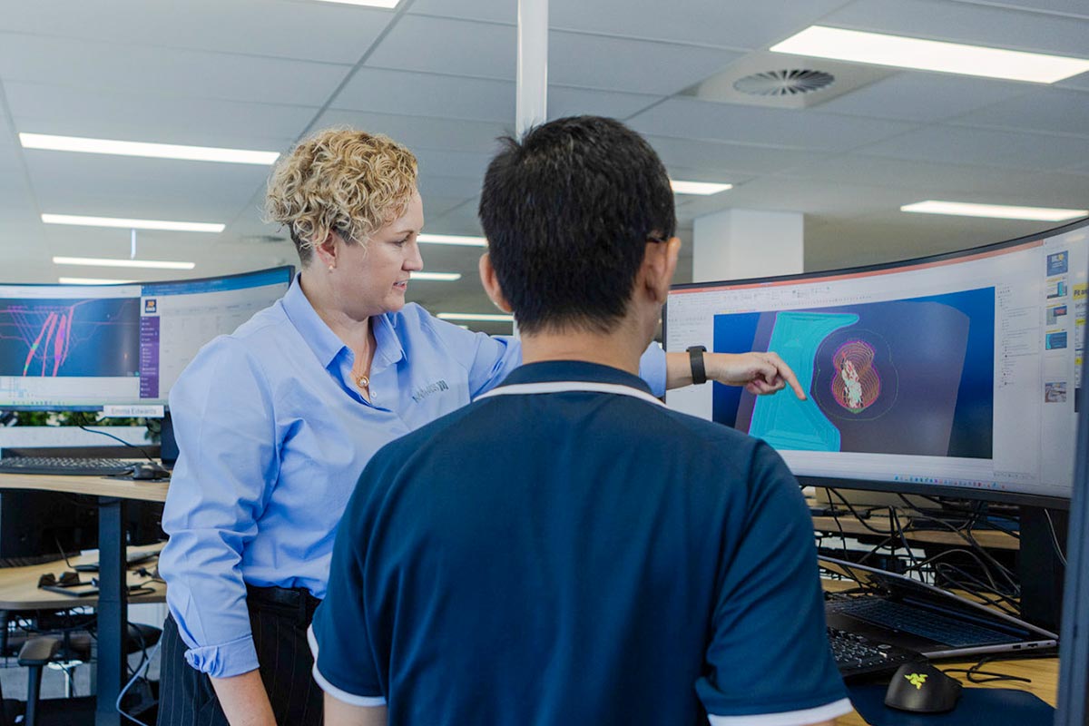 office-employees-pointing-at-computer-screen