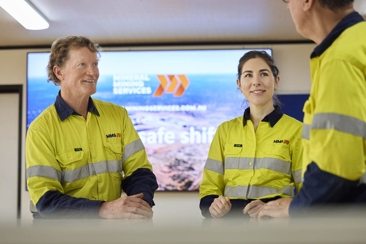 Three-MMS-miners-conversing-together