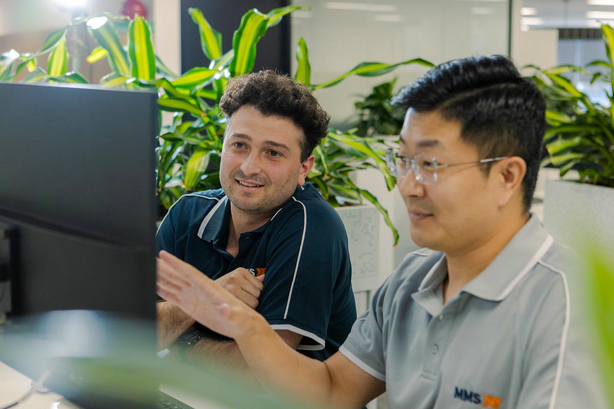 MMS-employees-behind-computer-screen